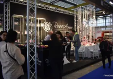 Busy at the booth of RoseAmor, a company that preserves roses. 